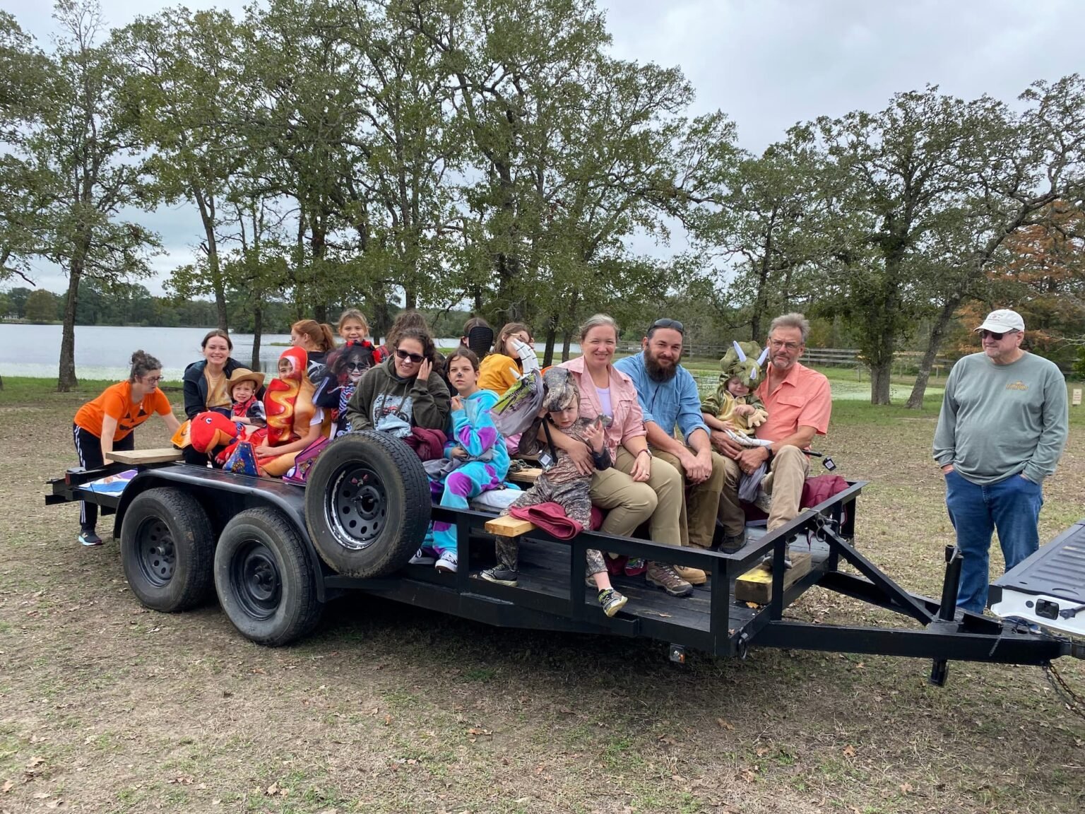 Smiling people in a hay ride.